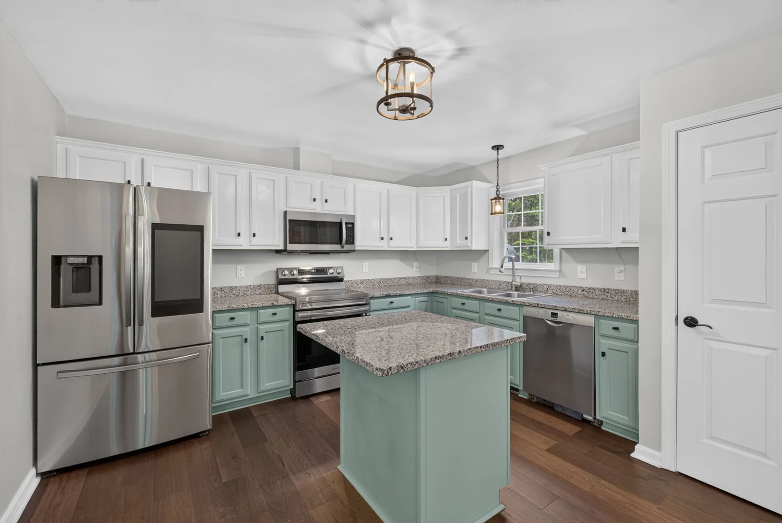 White kitchen with sage island in an Alton, NH home
