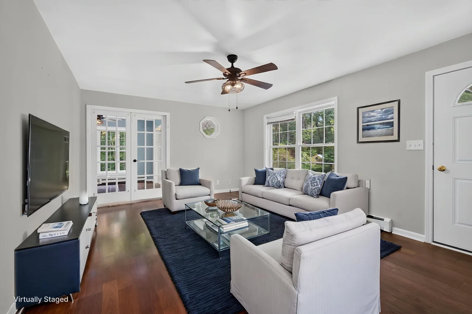 Bright living room with hardwood floors in an Alton, NH home