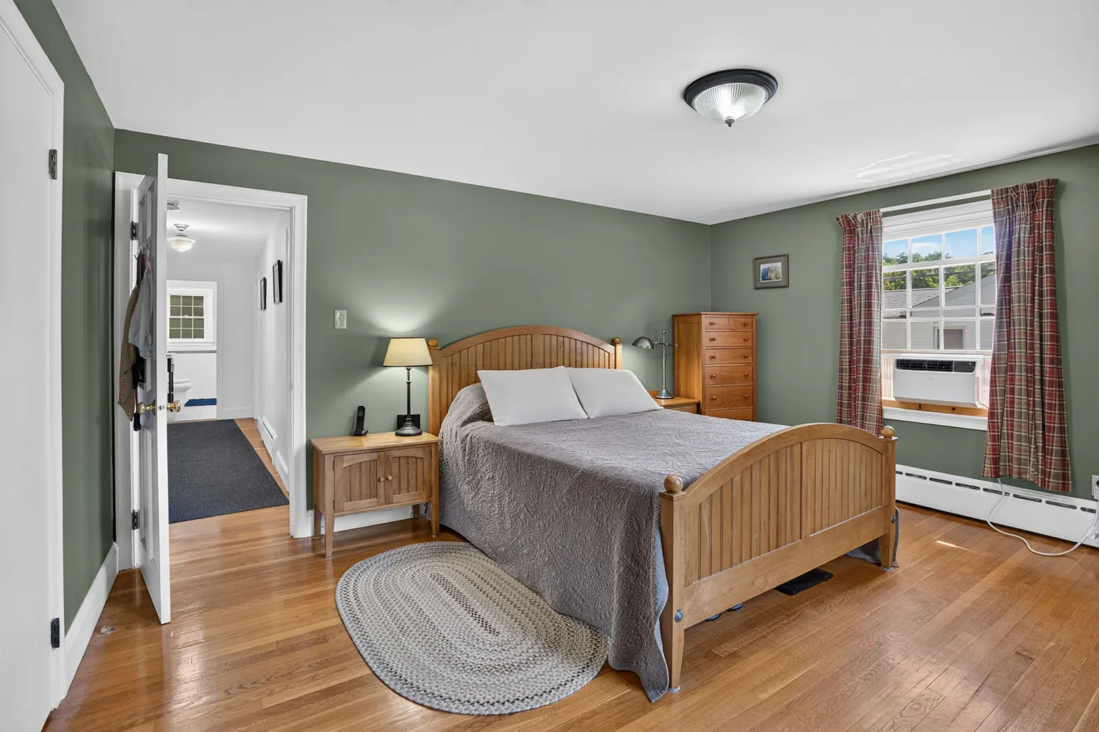 Bedroom with hardwood floors in a home on Lowell St in Andover, MA