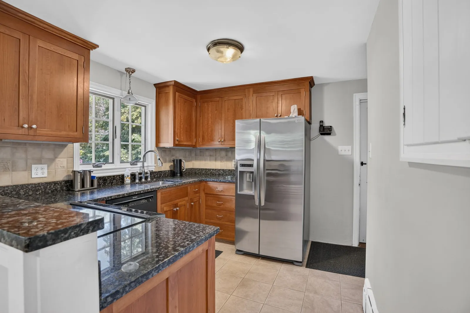 Kitchen with wood cabinets and stainless appliances in an Andover, MA home