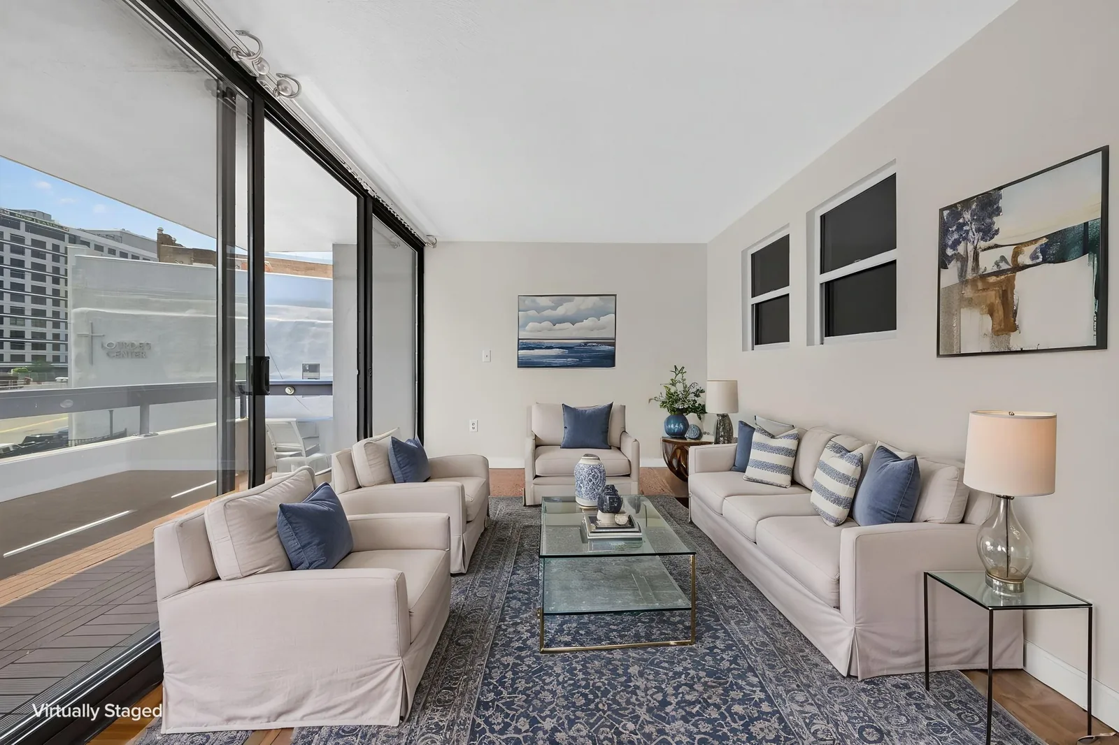 Virtually staged living room with city views in a Boston, MA condo