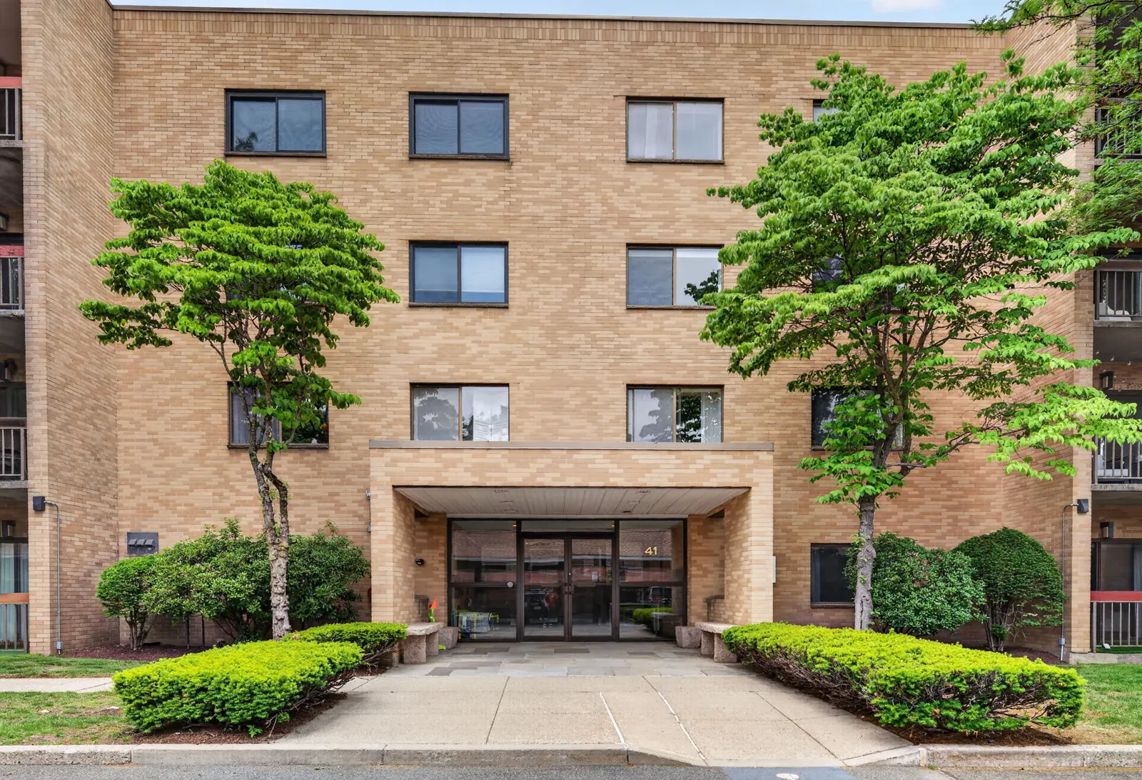 Front entrance of a condo building on Centre St in Brookline, MA