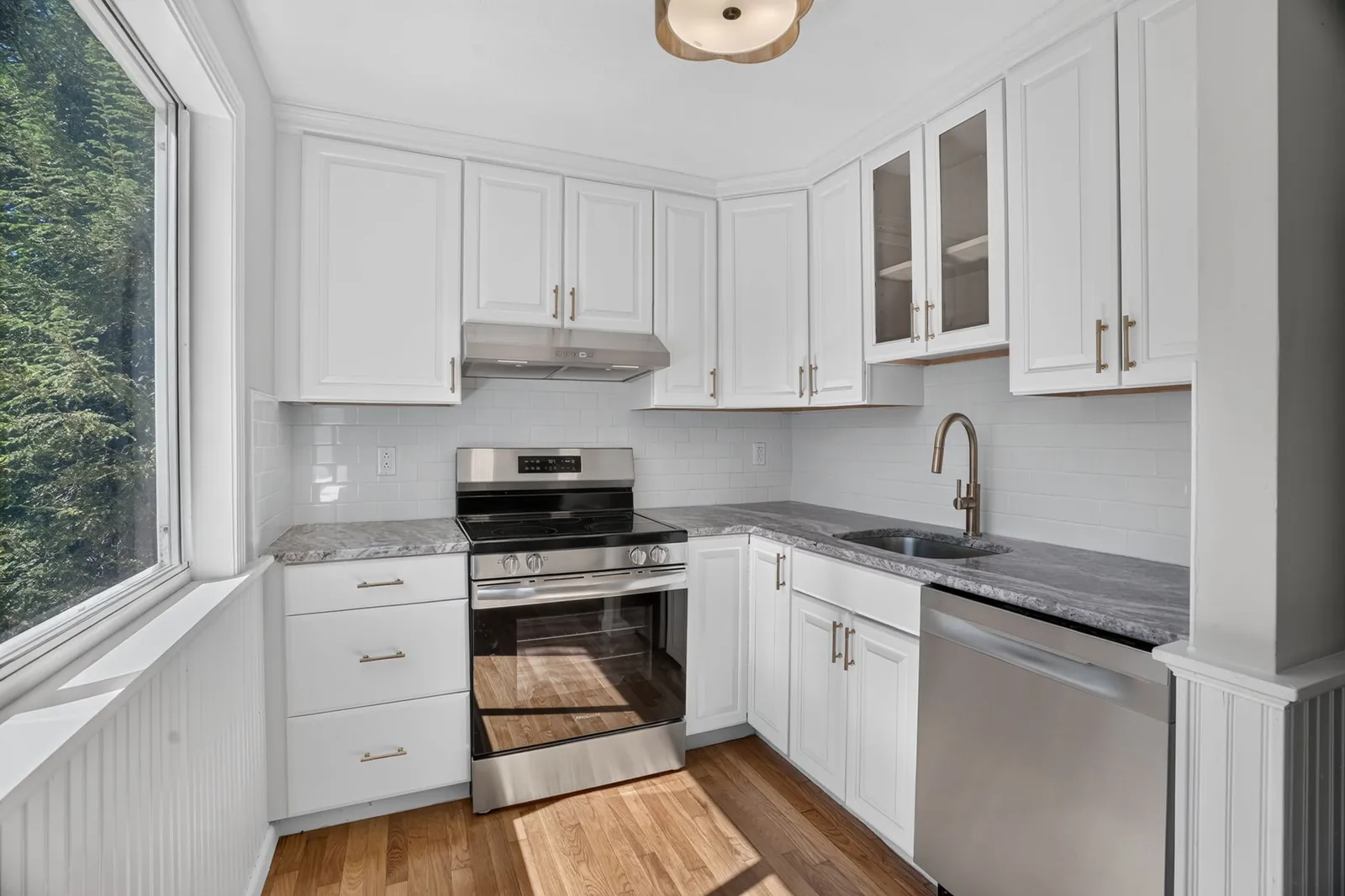 Renovated condo kitchen with white cabinets and stainless appliances in Ipswich, MA