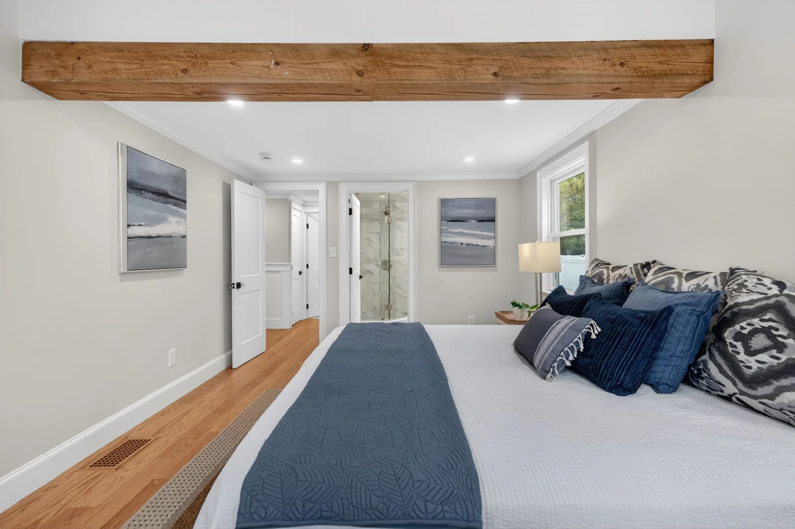 Primary bedroom with exposed beam in a Newburyport, MA home