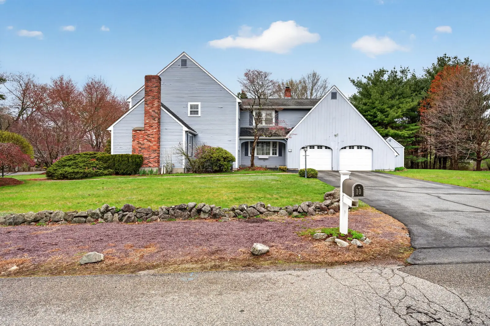 Colonial home and front lawn on Olympic Ln in North Andover, MA