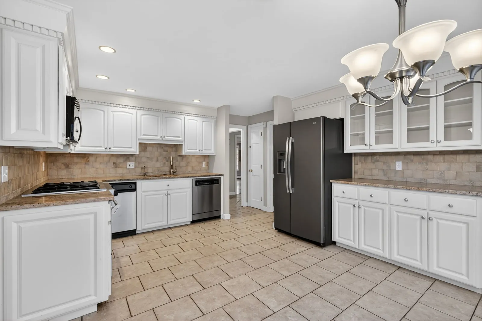 White kitchen with granite counters in a North Andover, MA home