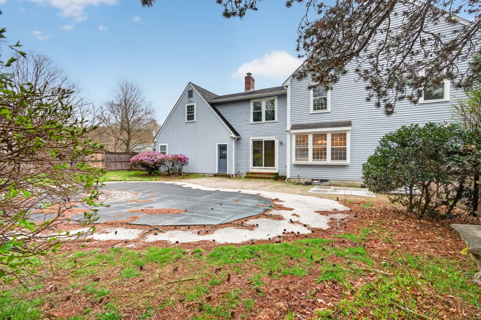 Side exterior and yard of a home on Olympic Ln in North Andover, MA