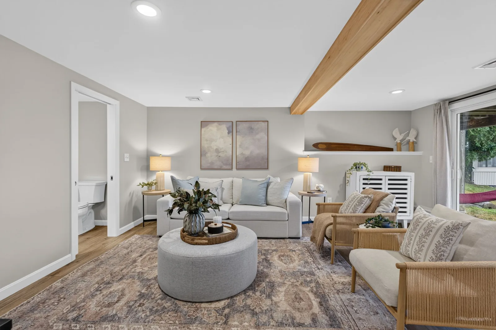 Living room with exposed beam in a lakefront home in Sandown, NH