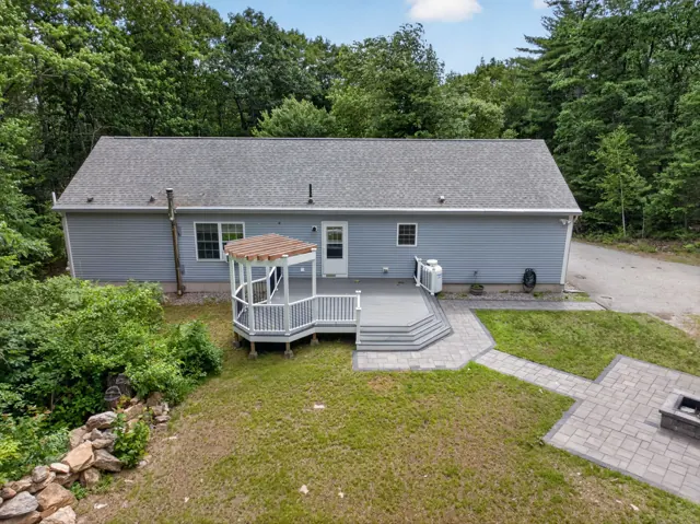 Ranch home with deck and wooded lot on Old Wolfeboro Rd in Alton, NH