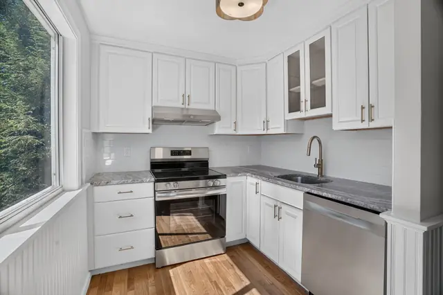 Renovated condo kitchen with white cabinets and stainless appliances in Ipswich, MA