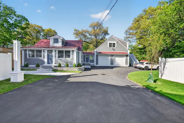 Front exterior and driveway of a renovated home on Merrimac St in Newburyport, MA